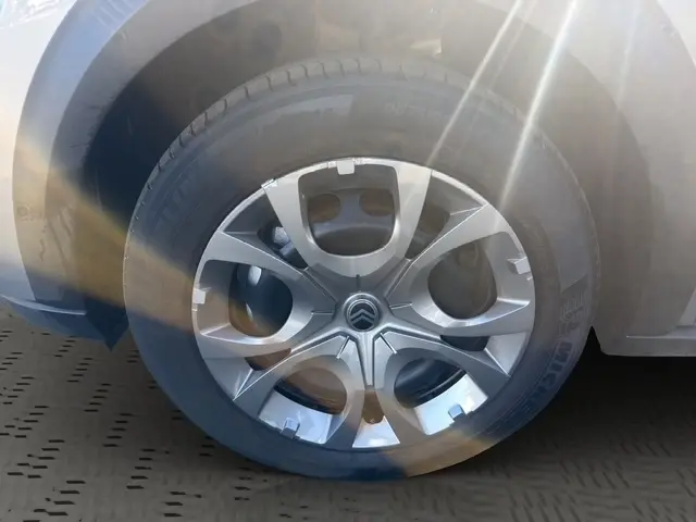 Gros plan sur la roue avant droite d’une Citroën C3 gris foncé 2025 avec jante alliage et logo Citroën central.
