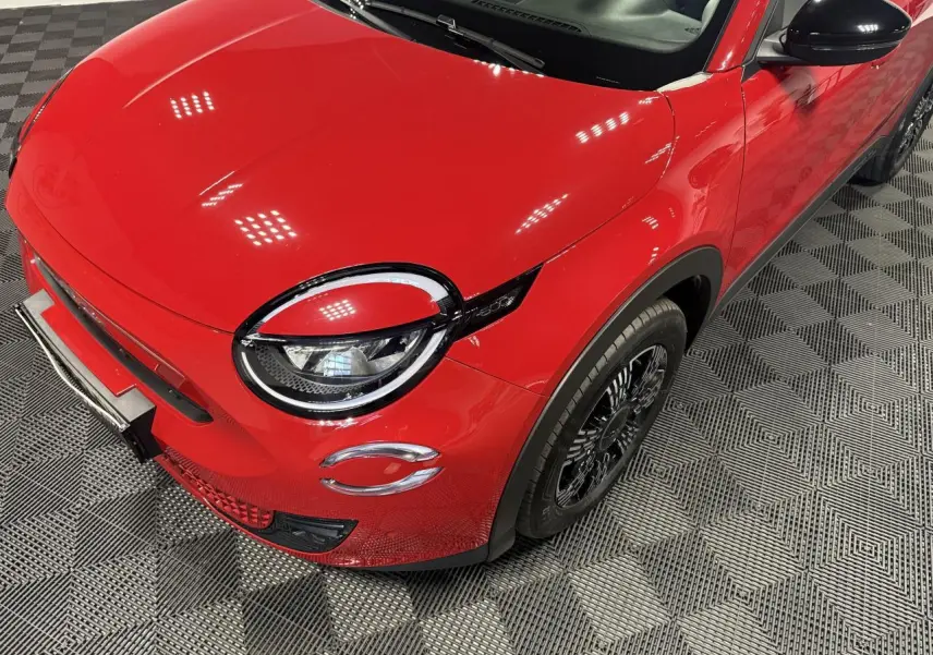 Vue 3/4 avant droit d'une FIAT 600 rouge foncé avec phares LED et coques de rétroviseurs noires brillantes.