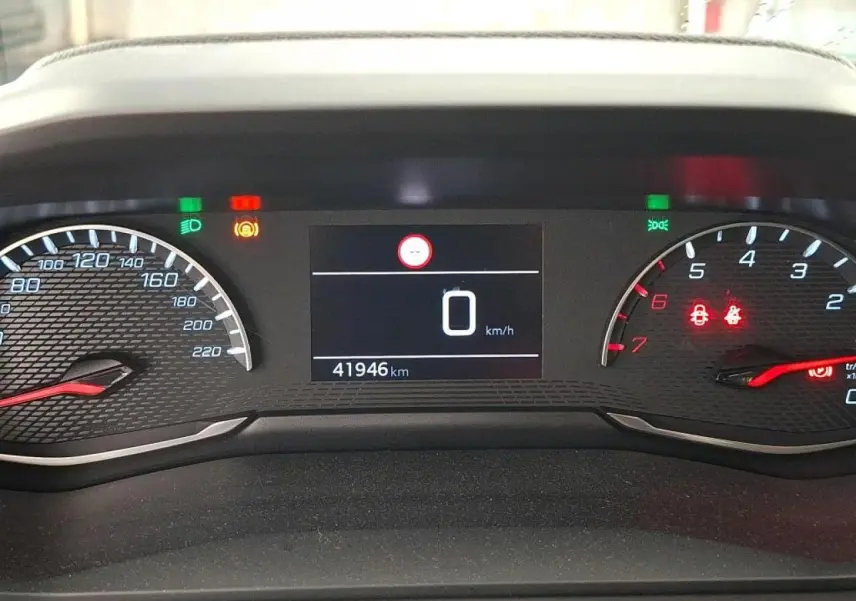 Vue rapprochée du combiné d'instruments numérique de la Peugeot 208, affichant 41 946 km et voyants allumés.