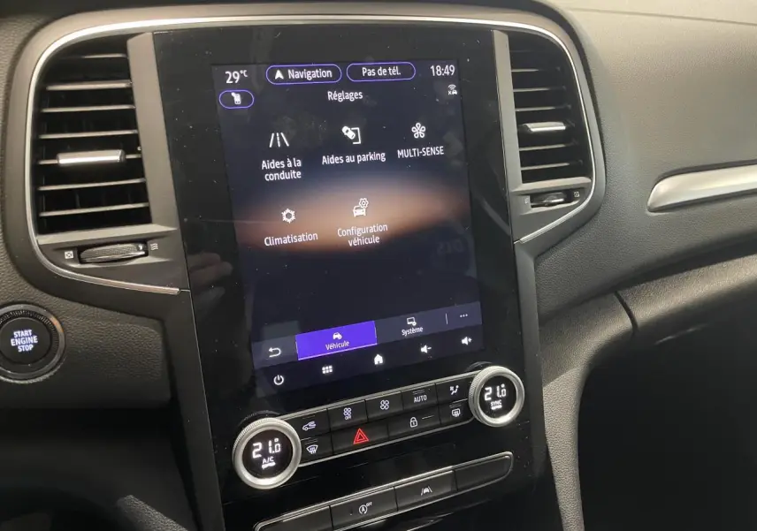 Vue rapprochée de la console centrale tactile verticale de la Renault Mégane 2023 avec commandes climatisation et démarrage.