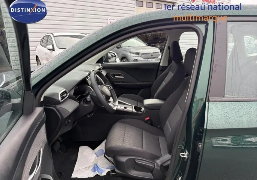 Vue intérieure côté conducteur du MG MOTOR ZS 2026 vert foncé, montrant sièges noirs et tableau de bord moderne.