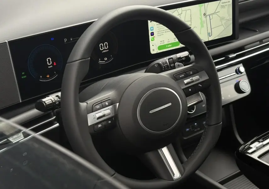 Vue rapprochée du volant noir et du tableau de bord numérique du Hyundai Tucson 2026 avec écran tactile intégré.