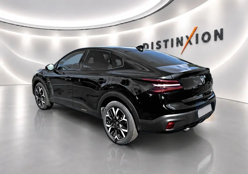 Vue 3/4 arrière droite d'une Citroën C4 X noire 2025 avec jantes alu et feux arrière LED distinctifs.