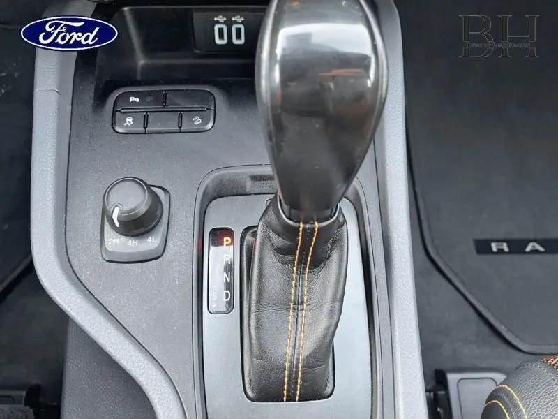 Vue rapprochée du levier de vitesses automatique en cuir noir avec surpiqûres orange du Ford Ranger Wildtrak 2017.