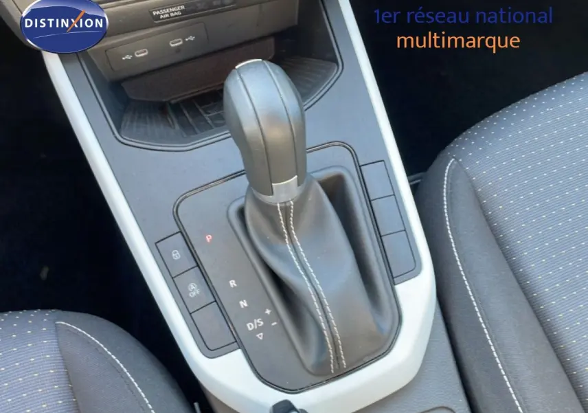 Gros plan sur la console centrale et levier de vitesse automatique en cuir noir avec surpiqûres blanches du SEAT Arona 2025.