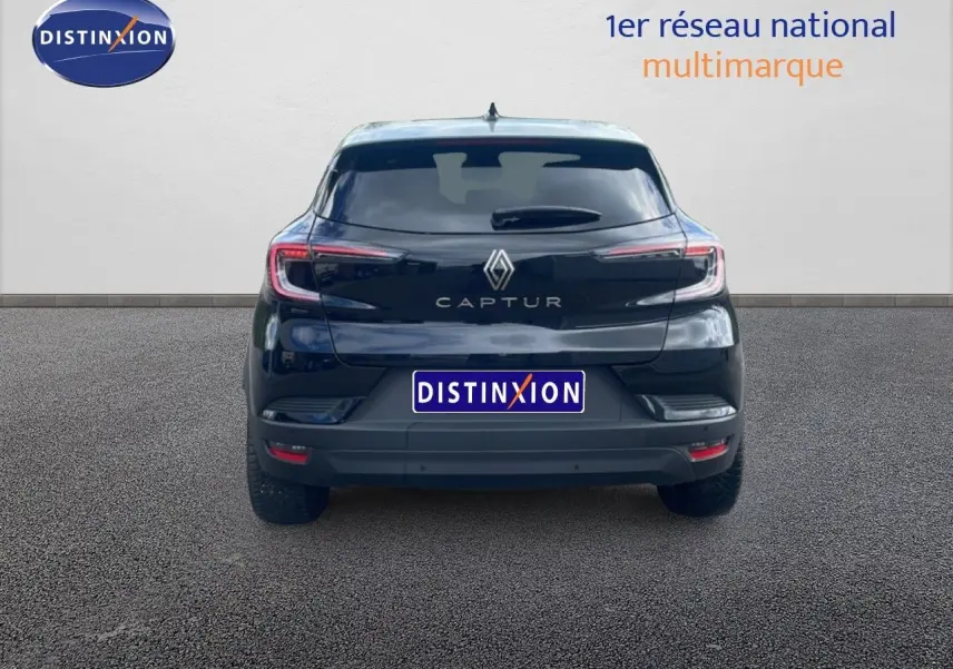 Vue arrière d'un Renault Captur noir étoile métal avec toit gris, version 2025, sur fond neutre.