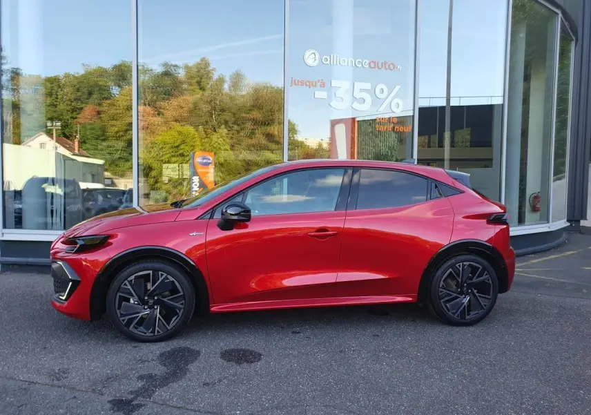 Renault Clio VI hybride rouge absolu vue de profil côté gauche, avec jantes alliage 18 pouces et vitres surteintées.
