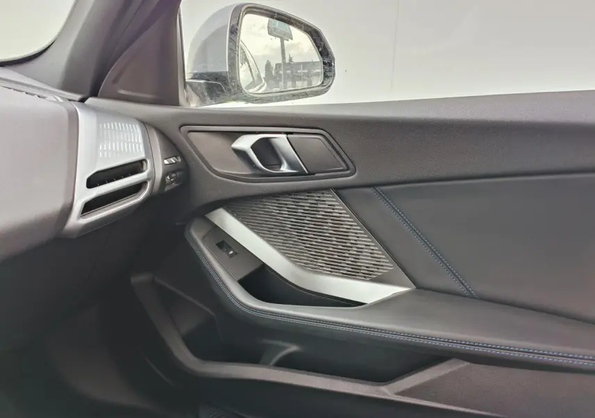 Gros plan sur le rétroviseur droit gris Skyscraper avec caméra intégrée sur BMW Série 1 2025 toit noir.