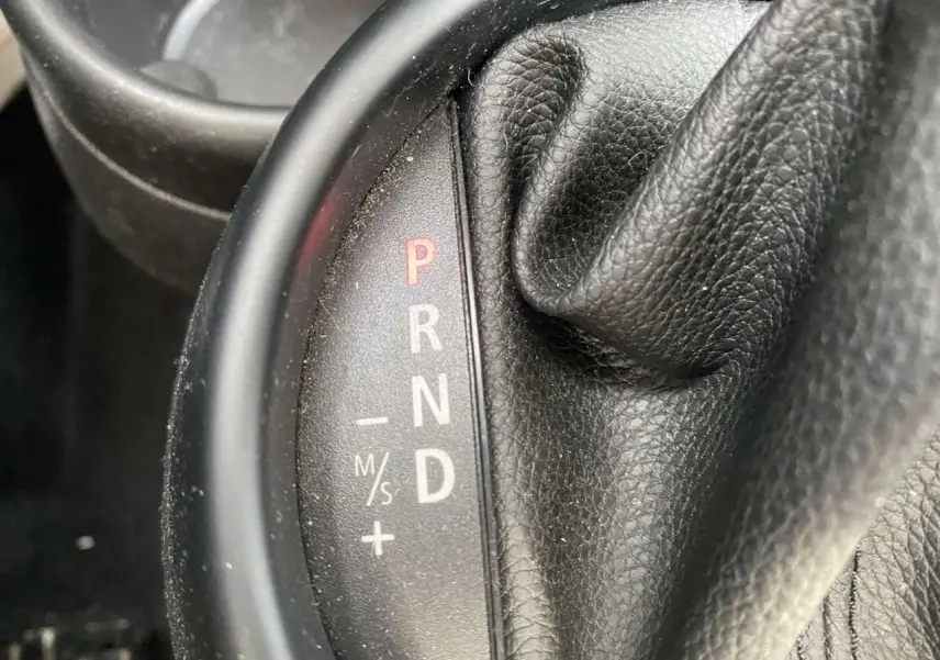 Gros plan sur le levier de vitesses automatique en cuir noir d’une MINI Countryman gris clair de 2015.