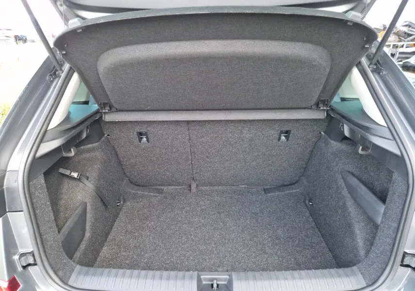 Coffre ouvert d'une Skoda Kamiq gris graphite, montrant un espace de chargement propre et bien fini.