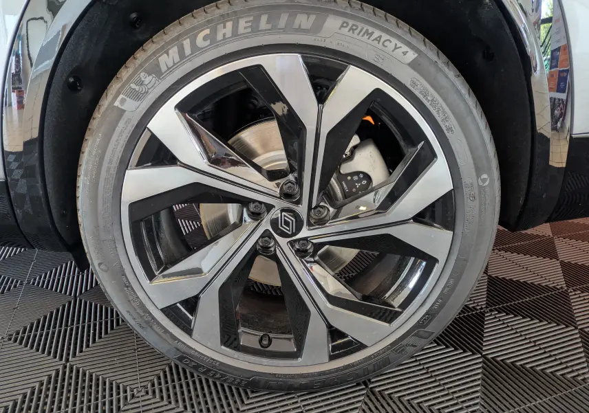 Gros plan sur la jante alliage 20'' Daytona noire et argentée du Renault Espace VI gris schiste, avec pneu Michelin Primacy 4.