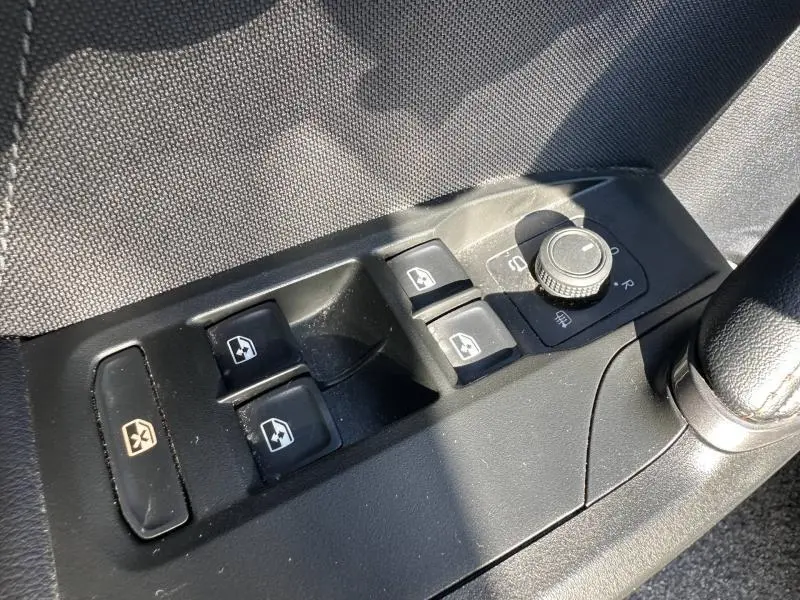 Gros plan sur les commandes des vitres et rétroviseurs côté conducteur du CUPRA Formentor blanc Nevada 2025.