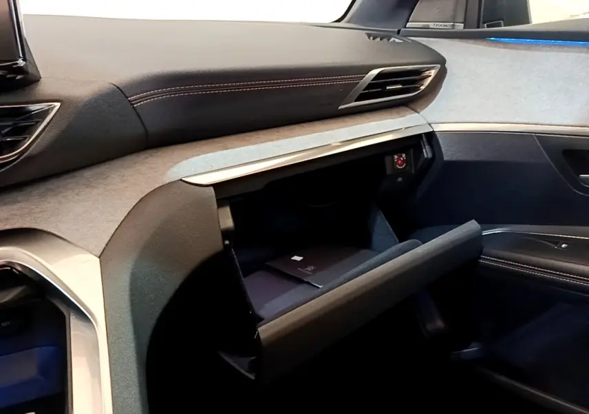 Intérieur côté passager du Peugeot 3008 GT Pack 2022, boîte à gants ouverte avec finition tissu et cuir noir.