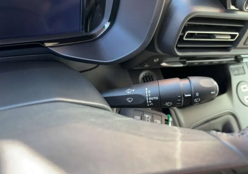Gros plan sur la commande des essuie-glaces côté gauche du tableau de bord du Citroën Berlingo 2026 intérieur noir.