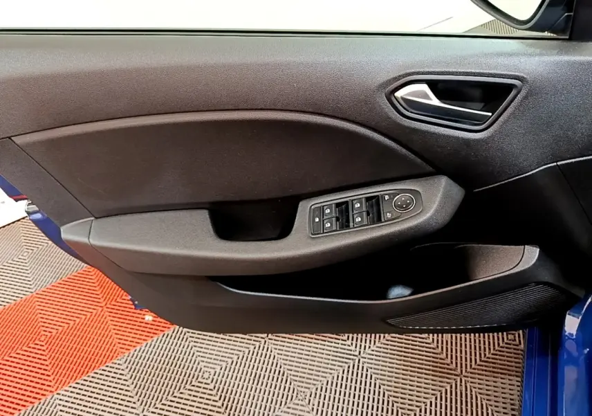 Vue rapprochée de la porte avant gauche noire avec commandes électriques sur une Renault Clio bleu visible au bord.