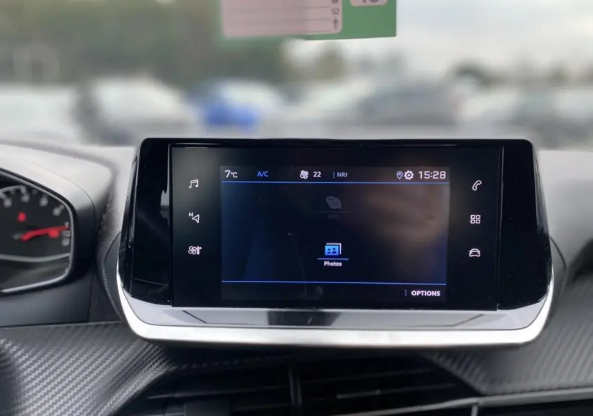 Écran tactile central du Peugeot 2008 2021, affichant l'interface multimédia avec commandes tactiles sur fond noir.