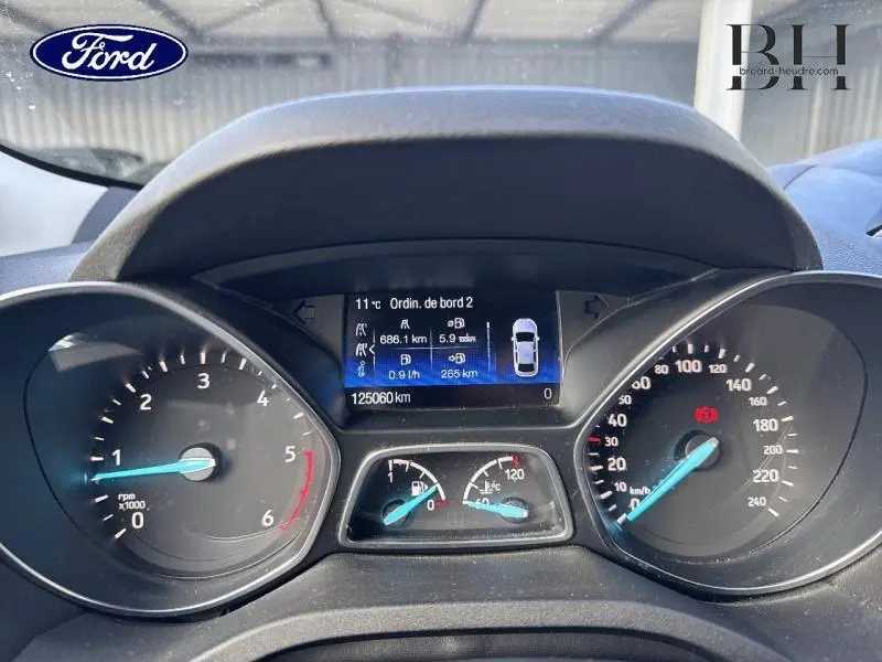 Vue rapprochée du tableau de bord du Ford Kuga gris lunaire 2017, affichant compteurs et écran multifonction.