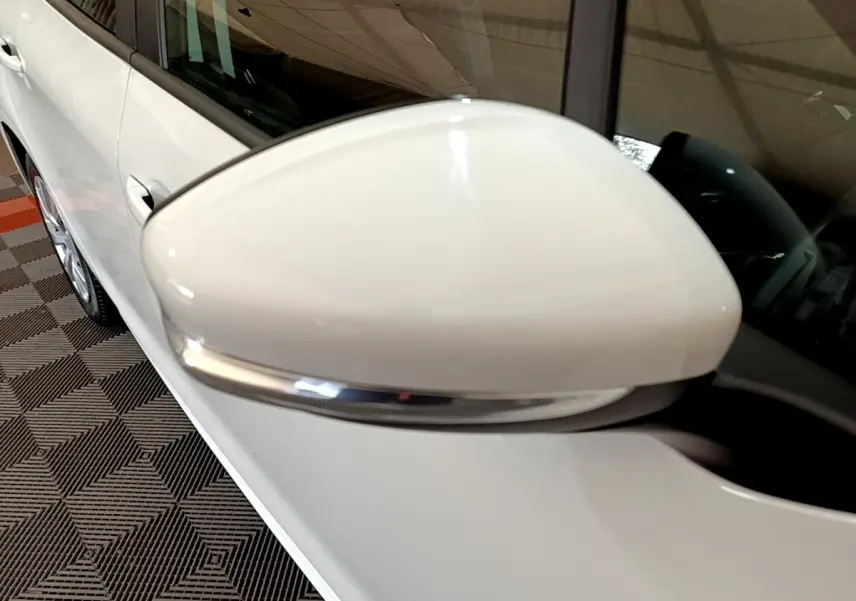 Gros plan sur le rétroviseur droit blanc avec clignotant intégré de la Peugeot 208 blanche, vue côté passager.