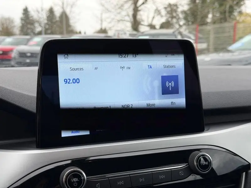Écran tactile central affichant la radio FM à 92.00 MHz dans un Ford Kuga 2024, intérieur gris et noir.