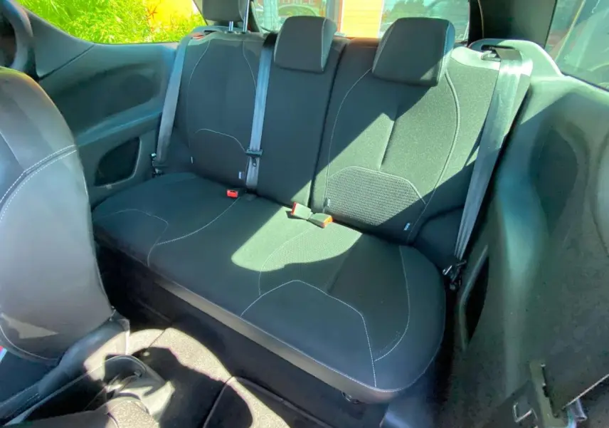 Vue intérieure arrière de la banquette noire avec surpiqûres blanches du DS3 2018, montrant les ceintures de sécurité et l'habitacle.