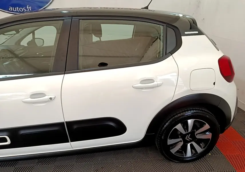 Vue latérale droite d'une Citroën C3 blanche 2021 avec toit noir et protections latérales noires distinctives.