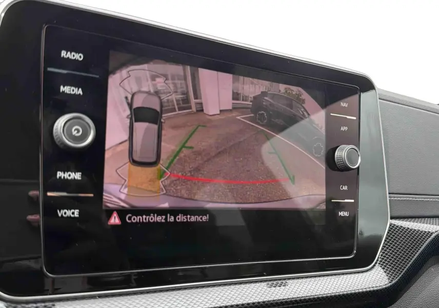 Écran tactile intérieur montrant la caméra de recul avec indications visuelles du Volkswagen T-Cross gris.