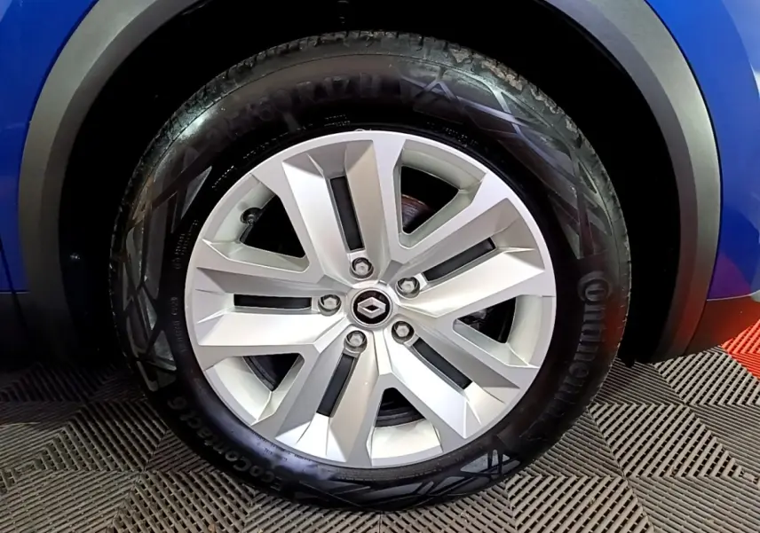 Gros plan sur la roue avant droite du Renault Captur bleu, mettant en valeur la jante alliage et le pneu Continental.