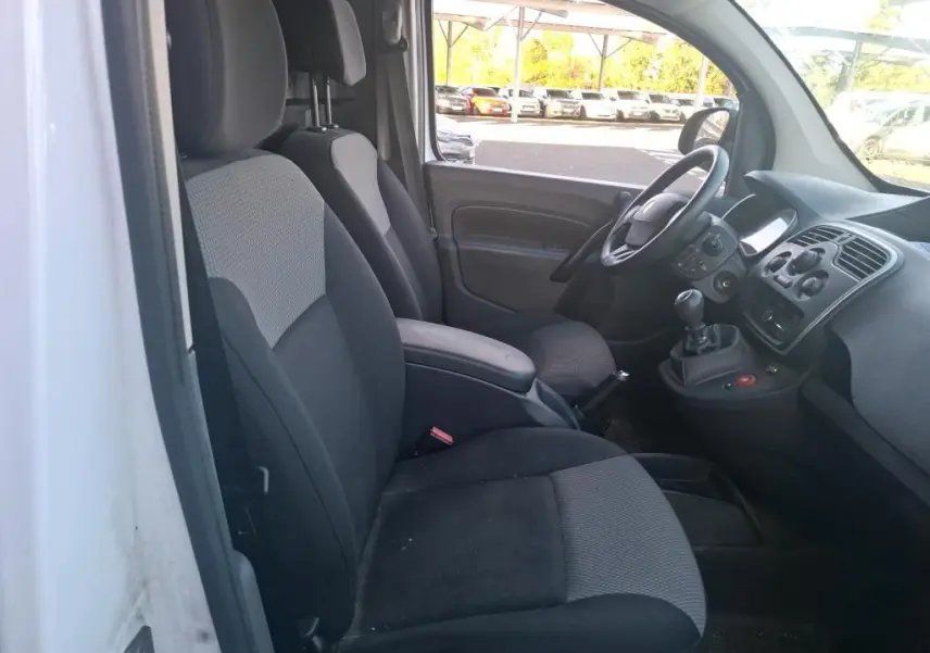 Vue arrière ouverte du Renault Kangoo blanc 2020, montrant l'aménagement intérieur en bois avec étagères et rangements.