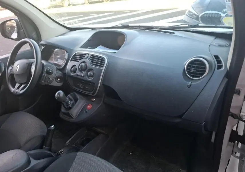 Vue de profil droit d’un Renault Kangoo blanc 2020 avec porte latérale coulissante ouverte montrant l’aménagement intérieur en bois.