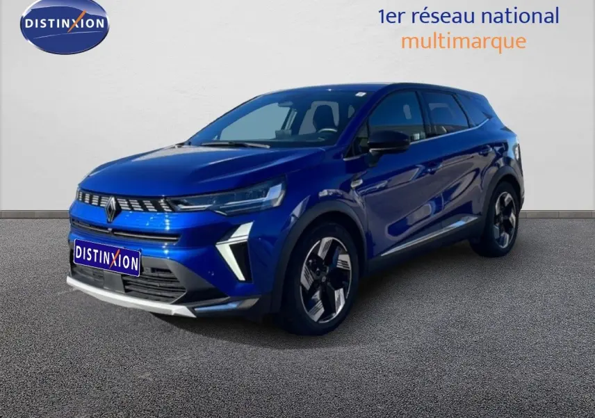 Renault Symbioz 2025 bleu Iron Metal en 3/4 avant droit avec calandre lumineuse et jantes stylisées.