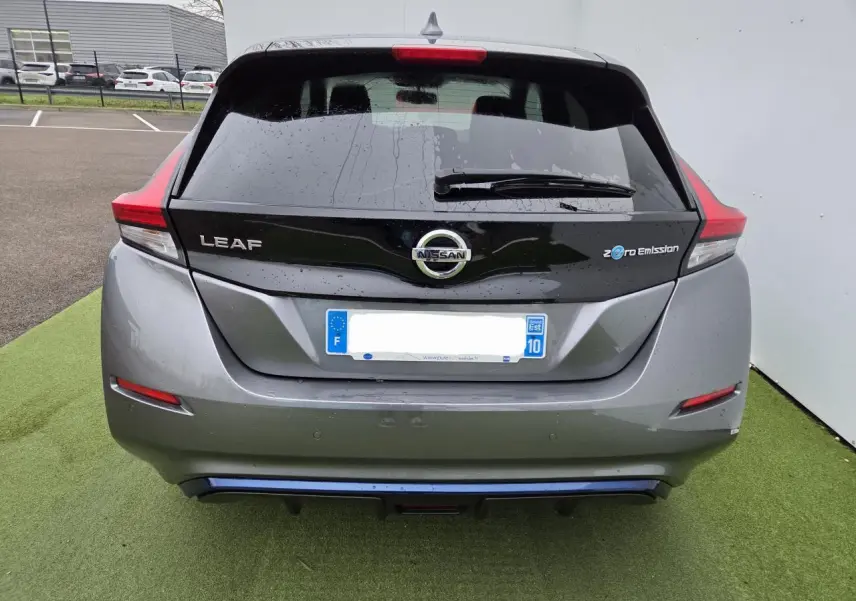 Vue arrière d'une Nissan Leaf II gris foncé métallisé avec logo Zero Emission et feux arrière LED distinctifs.