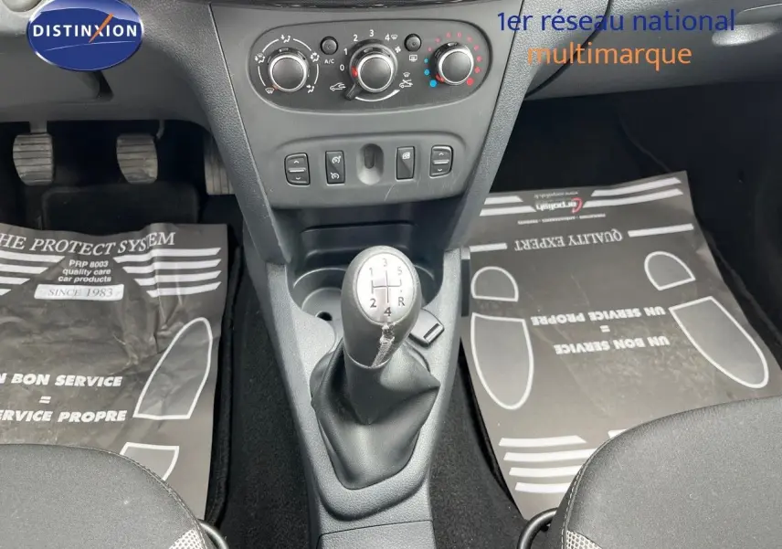Vue intérieure centrée sur la console centrale et levier de vitesse manuel d'une Dacia Sandero Stepway gris foncé de 2016.
