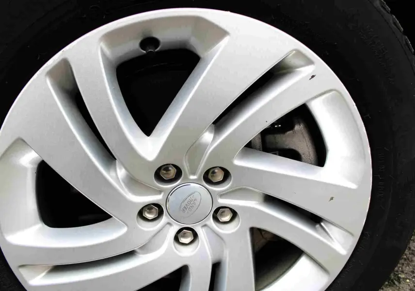 Gros plan sur la jante argentée du Range Rover Evoque 2023, mettant en valeur le logo Land Rover au centre.