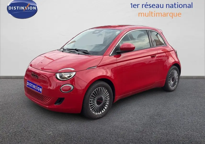 Vue 3/4 avant droite d'une FIAT 500e rouge électrique avec jantes classiques et phares ronds distinctifs.