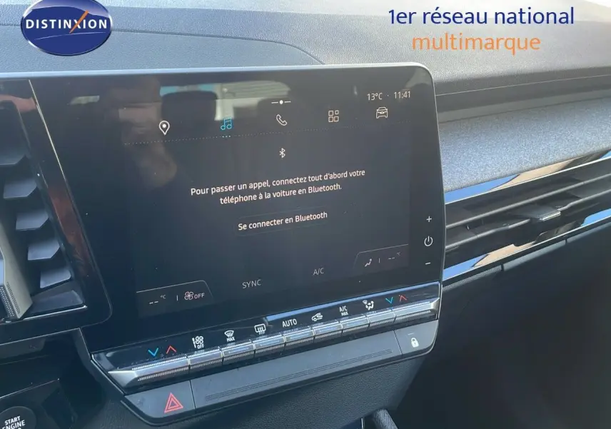Écran tactile central du tableau de bord du Renault Austral blanc glacier 2023, avec commandes climatisation visibles.
