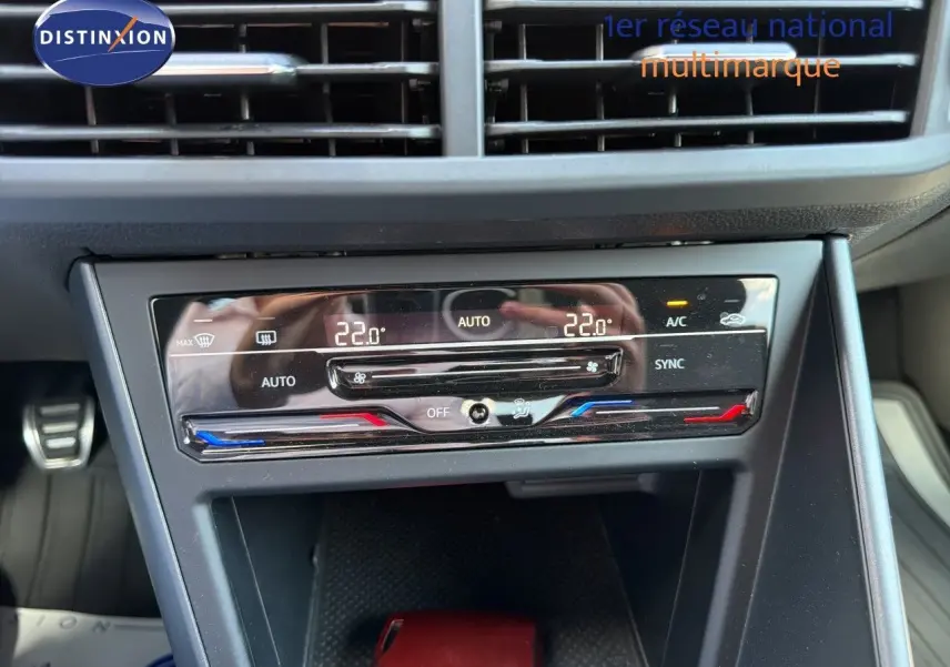 Vue rapprochée du tableau de bord de la Volkswagen Polo rouge Roi 2023, avec commandes de climatisation digitale.