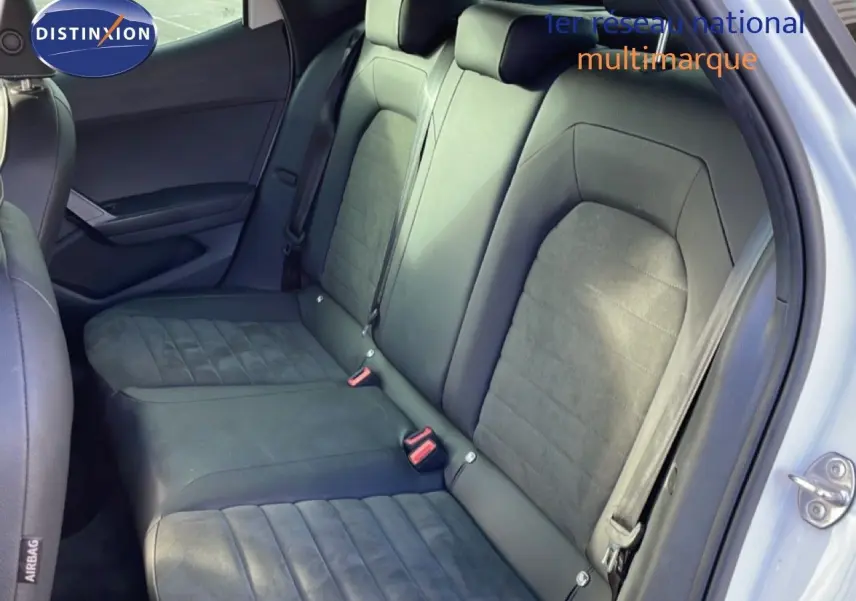 Vue intérieure des sièges arrière en cuir noir et alcantara du SEAT Arona 2025, porte arrière ouverte côté droit.