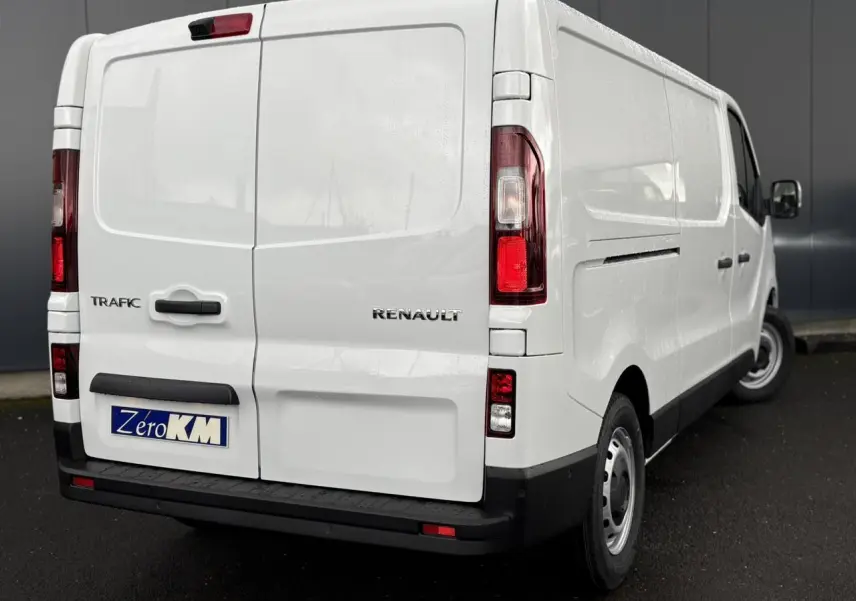 Vue 3/4 arrière droite du Renault Trafic Fourgon blanc Glacier avec portes arrière tôlées et plaque Zero KM.