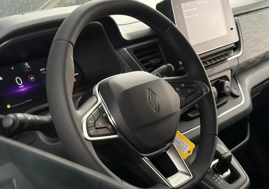 Vue rapprochée du volant multifonction et du combiné numérique du Renault Trafic Fourgon 2026, intérieur noir.