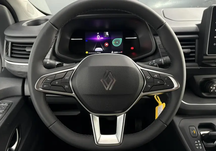 Vue rapprochée du volant noir et du tableau de bord numérique du Renault Trafic Fourgon blanc glacier 2026.