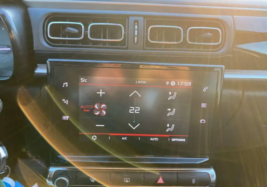 Gros plan sur l’écran tactile central de la Citroën C3 Shine 2023, affichant la climatisation automatique à 22°C.