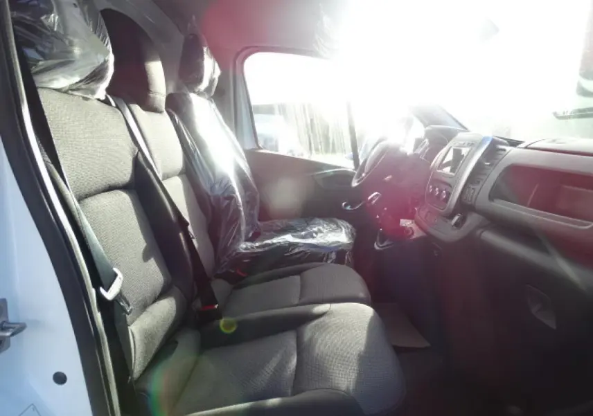 Vue intérieure côté conducteur du Fiat Talento Fourgon blanc 2020, montrant les sièges avant et le tableau de bord avec écran tactile.