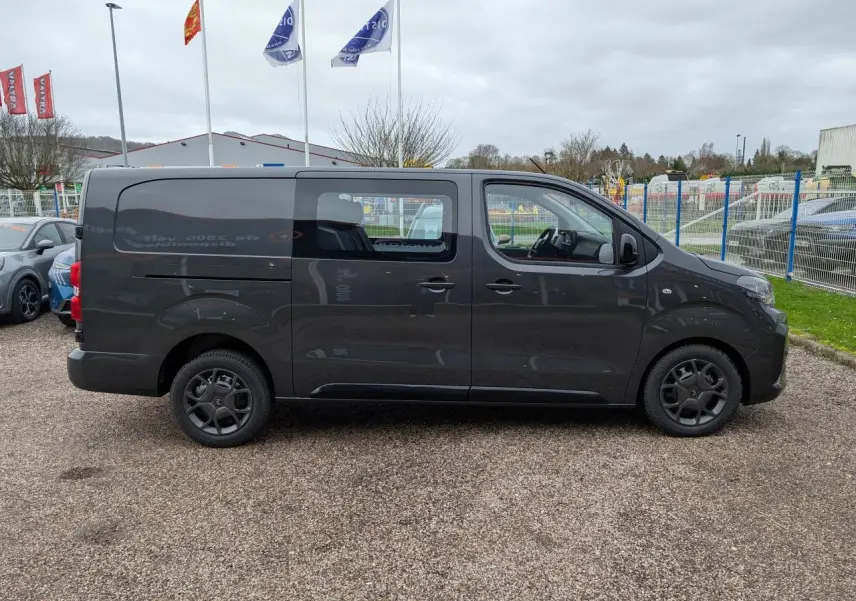 Vue de profil côté droit d’un Citroën Jumpy XL gris métallisé avec cabine approfondie et roues tôles noires.