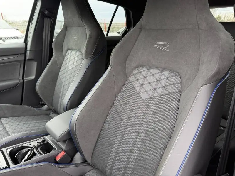 Vue intérieure rapprochée des sièges avant gris avec surpiqûres bleues et logo R de la Volkswagen Golf 2.0 TDI 150ch R-Line 2026.