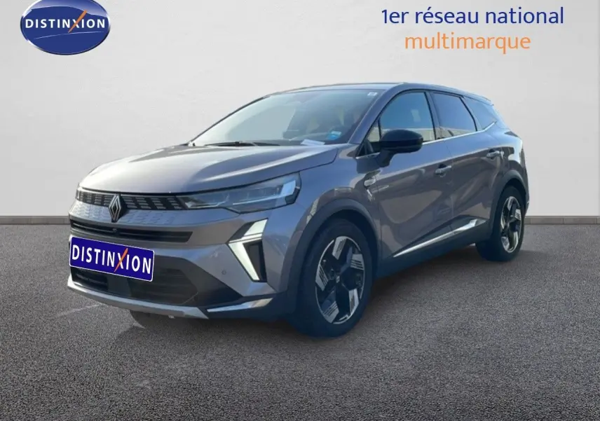 Renault Symbioz gris cassiopée métal en 3/4 avant droit, SUV hybride avec calandre distinctive et jantes bicolores.
