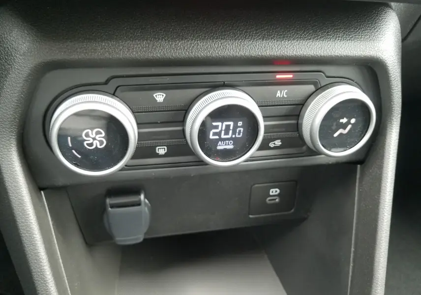 Gros plan sur les commandes de climatisation automatique de la Dacia Sandero Stepway 2025 en intérieur noir.