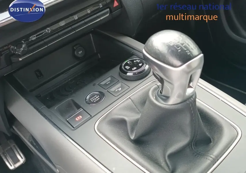 Gros plan sur la console centrale du Citroën C5 Aircross gris, mettant en valeur le levier de vitesse manuel et les commandes environnantes.