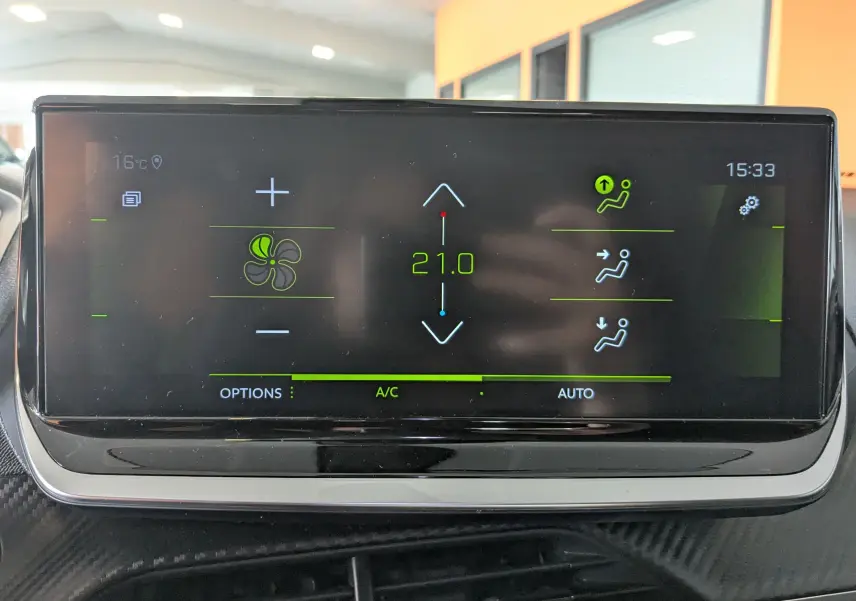 Écran tactile de la climatisation du Peugeot 2008 bleu, affichant une température de 21°C en mode automatique.