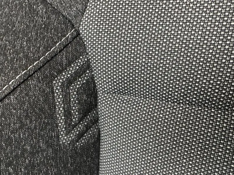 Gros plan sur le tissu gris texturé et la couture du siège avant du Renault Captur 1.6 E-Tech full hybrid 2025.