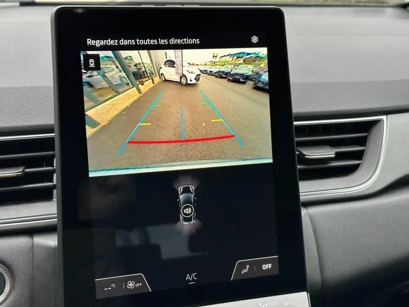 Écran tactile intérieur montrant la caméra de recul avec vue arrière sur un Renault Captur gris Rafale/Noir Etoilé.
